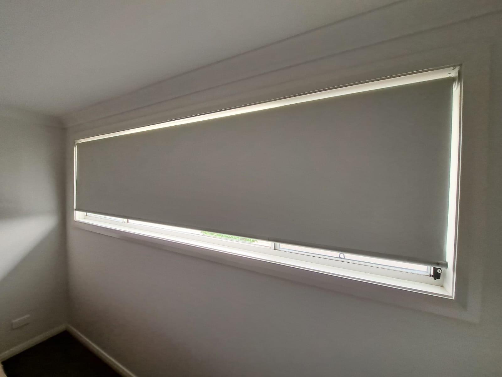 Premium grey blockout blind in a contemporary bedroom