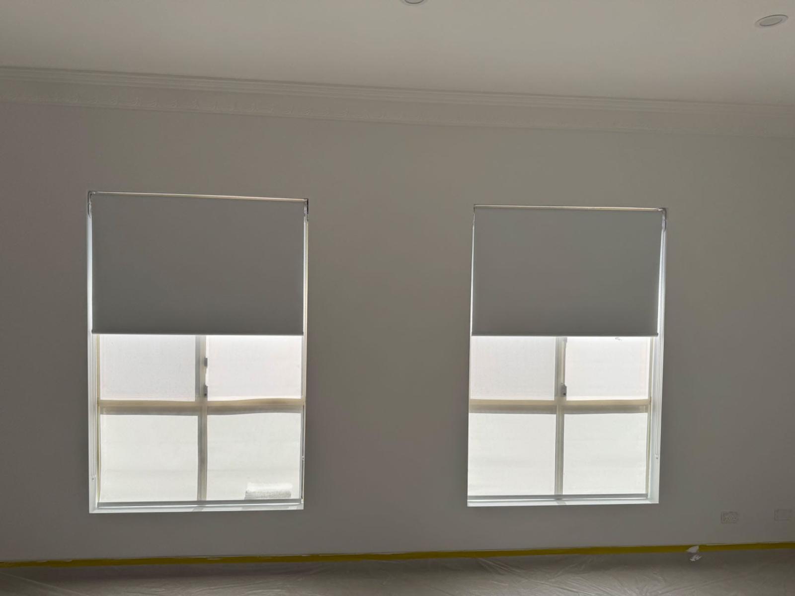 Twin roller blinds installed on feature windows